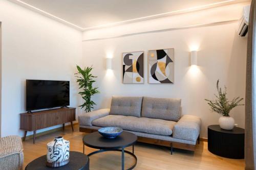 a living room with a couch and a tv at Touching Acropolis - Quiet & Elegant 1-Bdr Apt in Athens