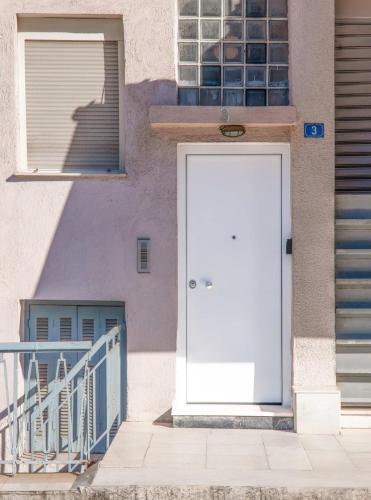 a white door on the side of a building at Touching Acropolis - Quiet & Elegant 1-Bdr Apt in Athens