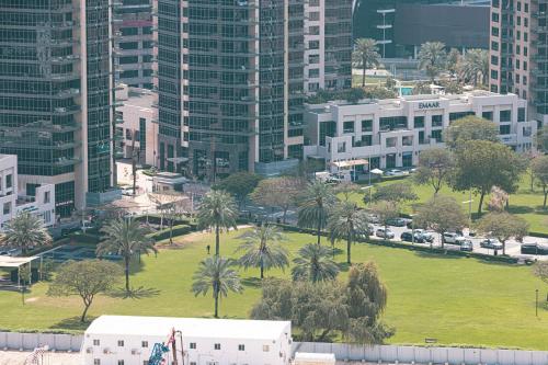 an aerial view of a park with palm trees and buildings at SmartStay at Burj Royale - Full Burj Khalifa View - Brand New Luxury Apartments in Dubai