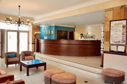 a lobby with a waiting area with a woman in a waiting room at The Oceanic 2 Bedroom with Ocean View - Self Catering Apartment in Durban