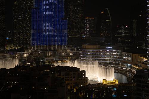 a view of a city at night with a fountain at SmartStay at Burj Royale - Full Burj Khalifa View - Brand New Luxury Apartments in Dubai