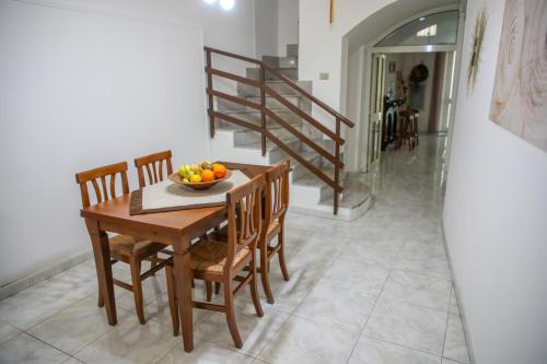- une table à manger et des chaises avec une corbeille de fruits dans l'établissement TARANTA HOUSE - Notte della Taranta casa con giardino, à Melpignano