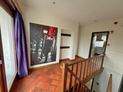 a hallway with a picture of a man on the wall at Résidence Thier Antoine in Noiseux