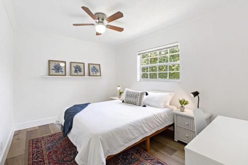 a white bedroom with a bed and a ceiling fan at Bright and Spacious 2 BR Apartment in Fort Lauderdale