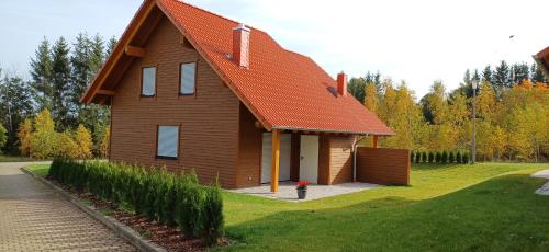a house with an orange roof and a fire hydrant at Premiumferienhaus Bhakti in Hasselfelde
