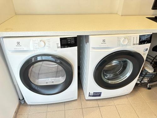 a washing machine and a dryer in a kitchen at Cosy and family friendly 3brd apartment in Akranes in Akranes
