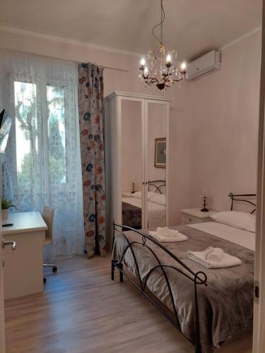 a bedroom with a bed and a chandelier at AlexaDom in Rome