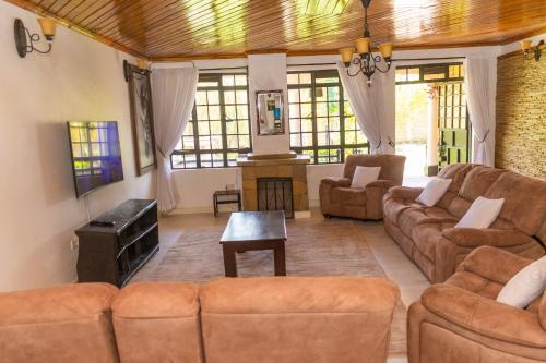 a living room with a couch and a table at Elevate by African Manor in Bungoma