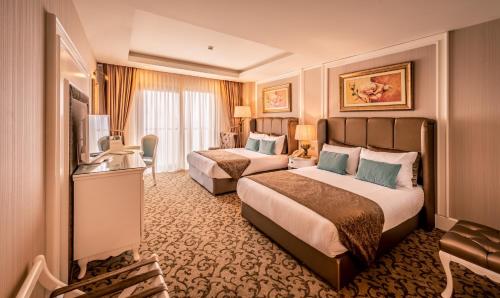 Кровать или кровати в номере Vuni Palace Hotel & Casino & SPA