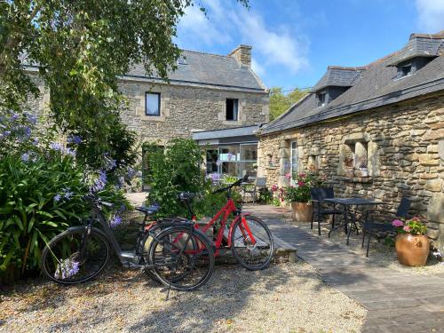 2 vélos garés devant un bâtiment en pierre dans l'établissement Domaine De Kéryel, à Plougonvelin