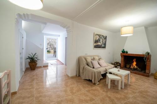 a living room with a couch and a fireplace at CASA MARÍA LA ROMANA in Torres
