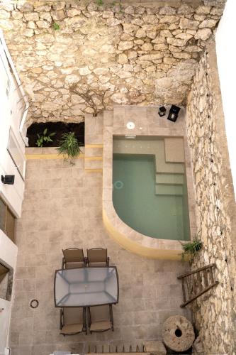 a swimming pool with two chairs and a bench at CASA MARÍA LA ROMANA in Torres