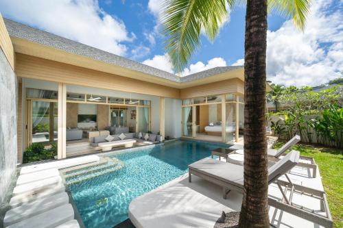 an exterior view of a villa with a swimming pool at Himmapana Villas - SHA Extra Plus in Kamala Beach