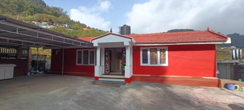 a red house with a red roof at QUEENS COTTAGE - individual cottage in Ooty