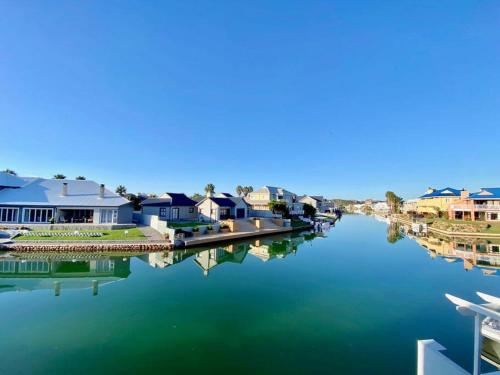 a view of a river with houses and condos at Canal 04 in Jeffreys Bay