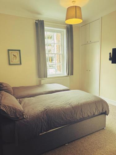 a bedroom with two beds and a window at Castle View, 94-96 Friar Lane in Nottingham