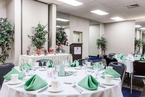 a banquet hall with white tables and green napkins at Albany Plaza Hotel in Albany