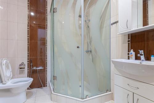 a bathroom with a shower and a toilet and a sink at Stay Inn apartments at Buzand 13 street in Yerevan