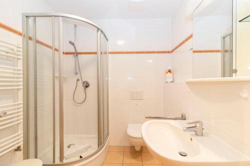 a bathroom with a shower and a sink and a toilet at Nordseeblick 5 in Cuxhaven