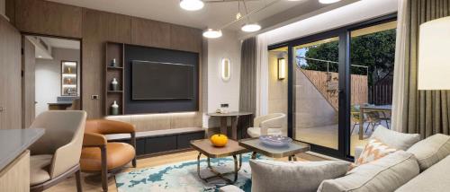 a living room with a couch and a television at Ankara HiltonSA in Ankara