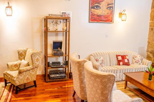 a living room with a couch and two chairs at Zereniti House in Muyaka