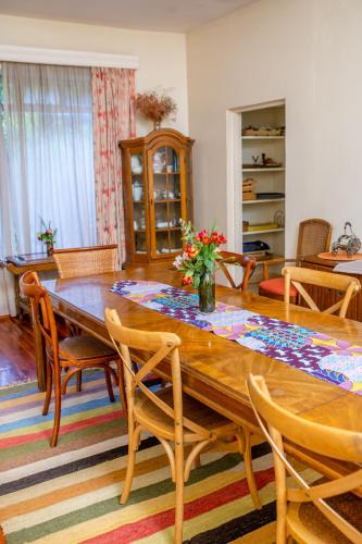 a dining room with a wooden table and chairs at Zereniti House in Muyaka