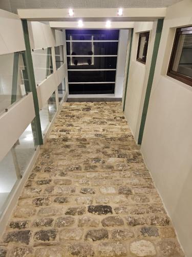 a hallway with a stone floor in a house at Hotel YIT Casa Grande in Jerez de la Frontera