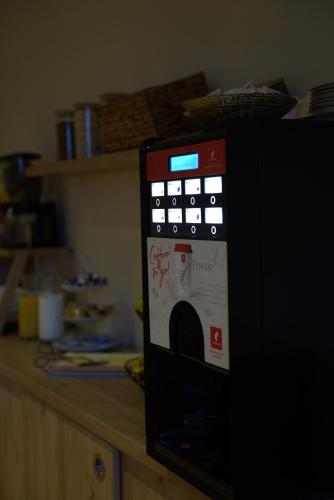 a black microwave oven with a bunch of papers on it at Boutique Hostel Livia in Metković