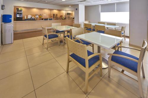 a dining room with tables and chairs and a counter at City Express by Marriott Xalapa in Xalapa