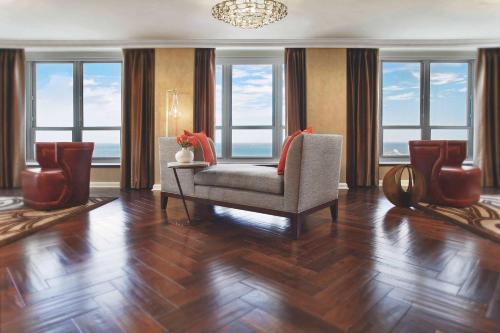 a living room with a chair and some windows at Hilton Chicago in Chicago