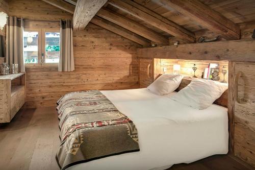 ラ・クリュサにあるChalet Patagonia - OVO Networkの木製の壁の客室の大型ベッド1台