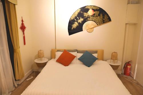 a bedroom with a bed with pillows and a moon at Central London Chinatown 1 bedroom 1 bathroom Flat in London