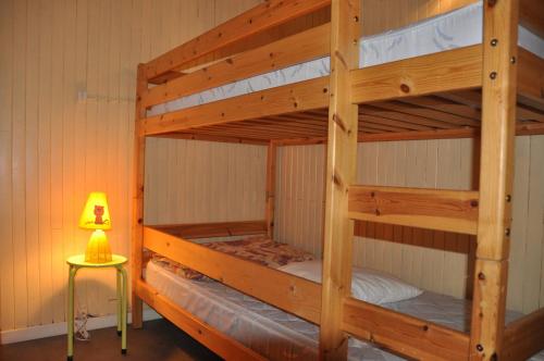 two bunk beds in a room with a lamp at Olympe - 104 - Studio - 4 pers in Les Deux Alpes