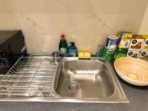 a kitchen sink with a dish rack in it at Central London Chinatown 1 bedroom 1 bathroom Flat in London