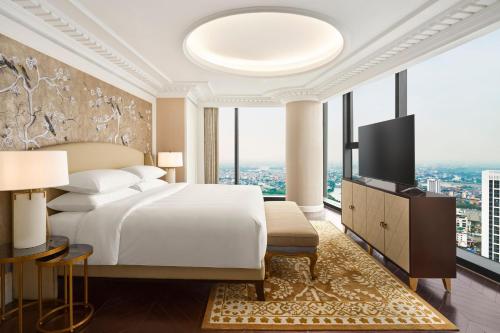 a bedroom with a bed and a large window at Sheraton Hai Phong in Hai Phong