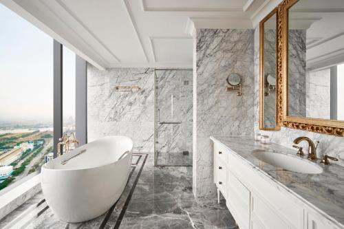 a bathroom with a tub and a sink and a shower at Sheraton Hai Phong in Hai Phong