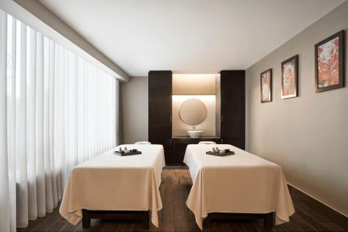 a room with two tables with white table cloth at Sheraton Hai Phong in Hai Phong
