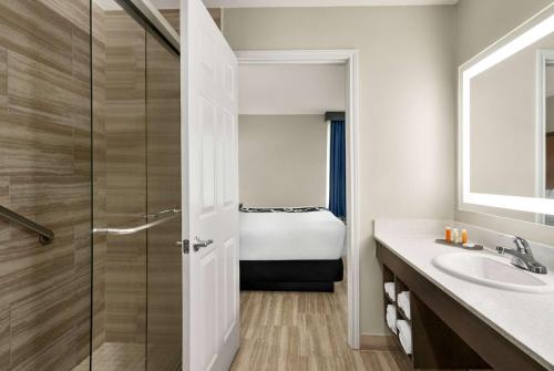 a bathroom with a shower and a sink at La Quinta by Wyndham Brownsville North in Brownsville