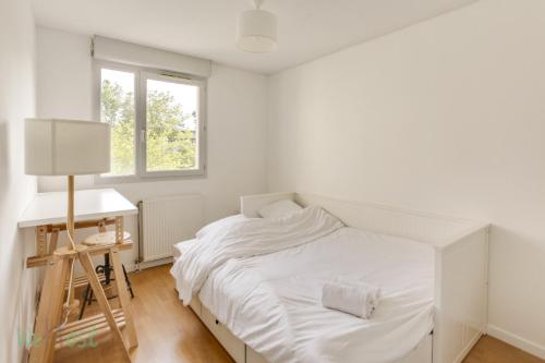 a white bedroom with a bed and a desk at CAEN31330 in Toulouse