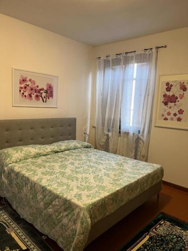 a bedroom with a bed and a window at Casa Elena in Manciano