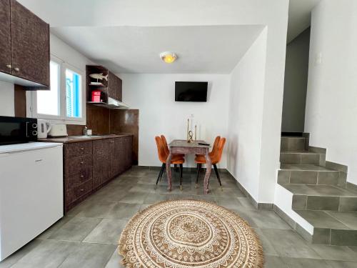 a kitchen and dining room with a table and chairs at Family Villages Santorini in Vlychada Beach