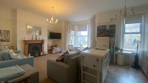 a living room with a couch and a table at St Johns Guest House in Weymouth