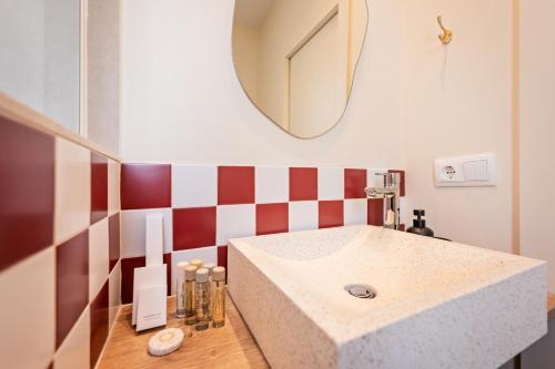 a bathroom with a sink and a mirror at Sweet Inn - Wellington in Barcelona