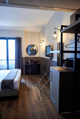 a hotel room with a bed and a desk at Hotel Concorde in Arona