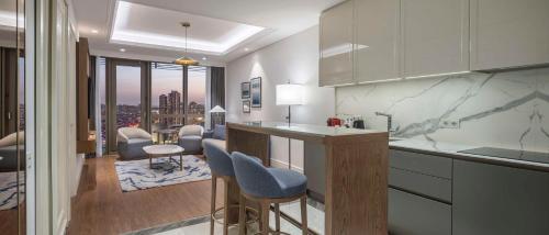 a kitchen with a counter and a living room at Hilton Mall Of Istanbul in Istanbul