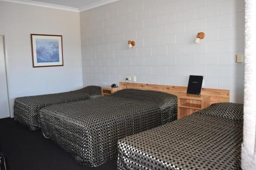 a hotel room with two beds and a desk at Black Diamond Motel in Blackwater