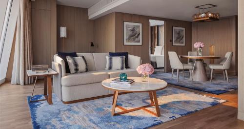 a living room with a couch and a table at Jumeirah Beach Hotel Dubai in Dubai