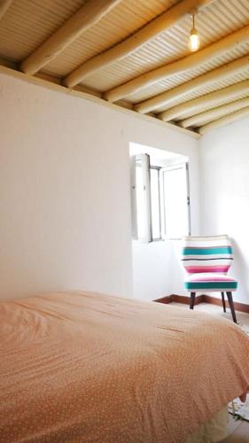 a bedroom with a bed and a blue chair at Artsy Short Term Rentals Monsanto in Monsanto