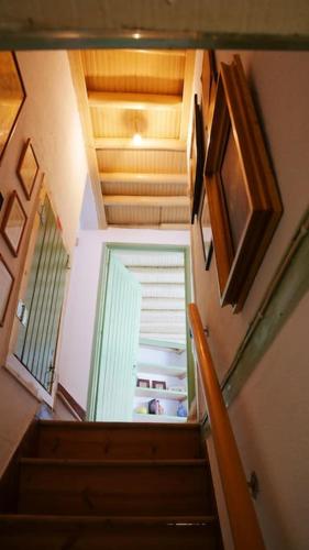 a staircase with an open door to a refrigerator at Artsy Short Term Rentals Monsanto in Monsanto