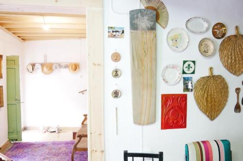 a wall with plates and bowls on a wall at Artsy Short Term Rentals Monsanto in Monsanto